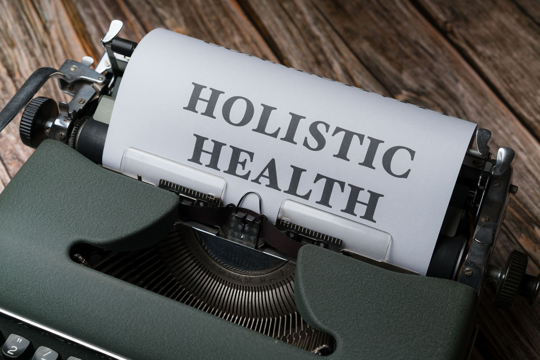 a typewriter with the word holistic health on it