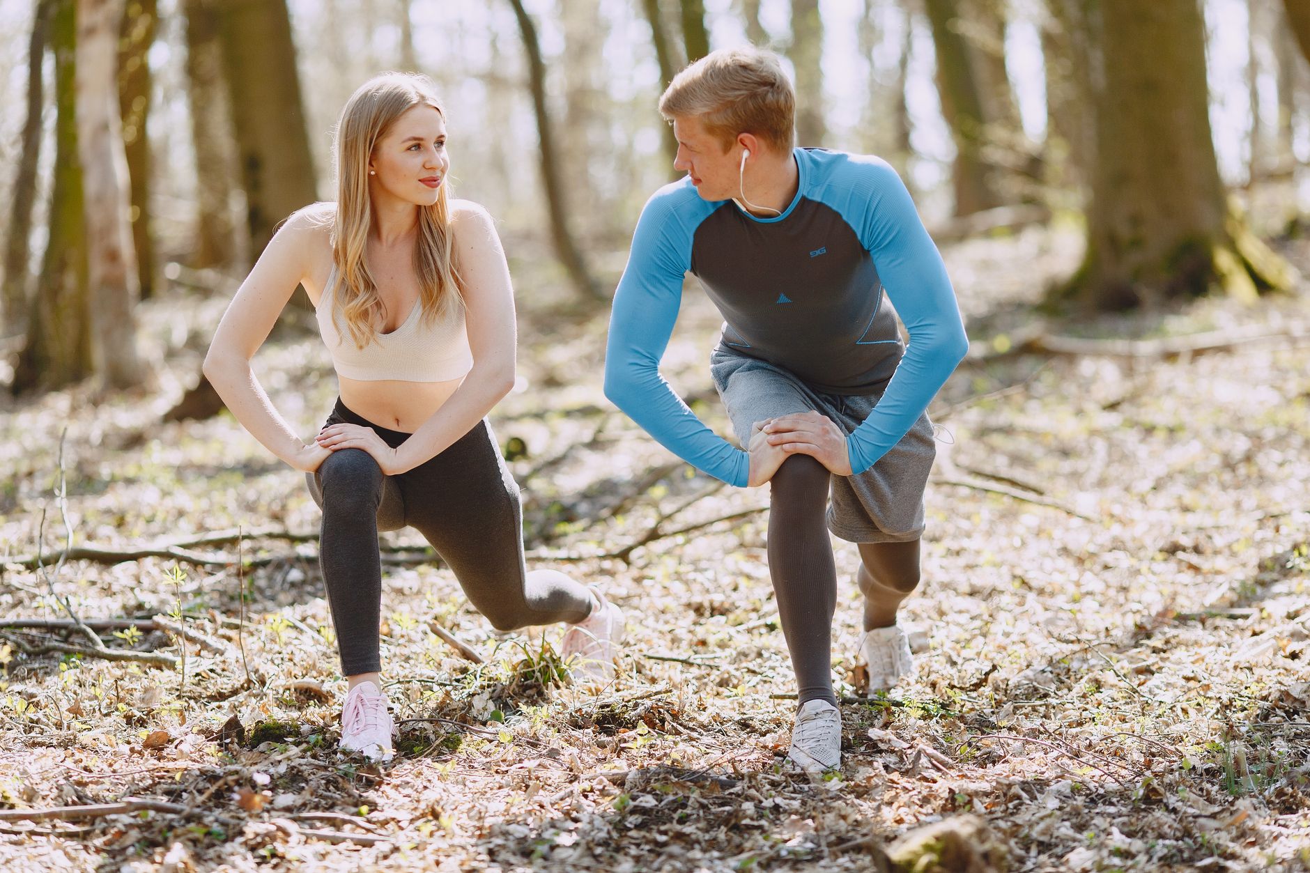 photo of couple exercising while looking at each other