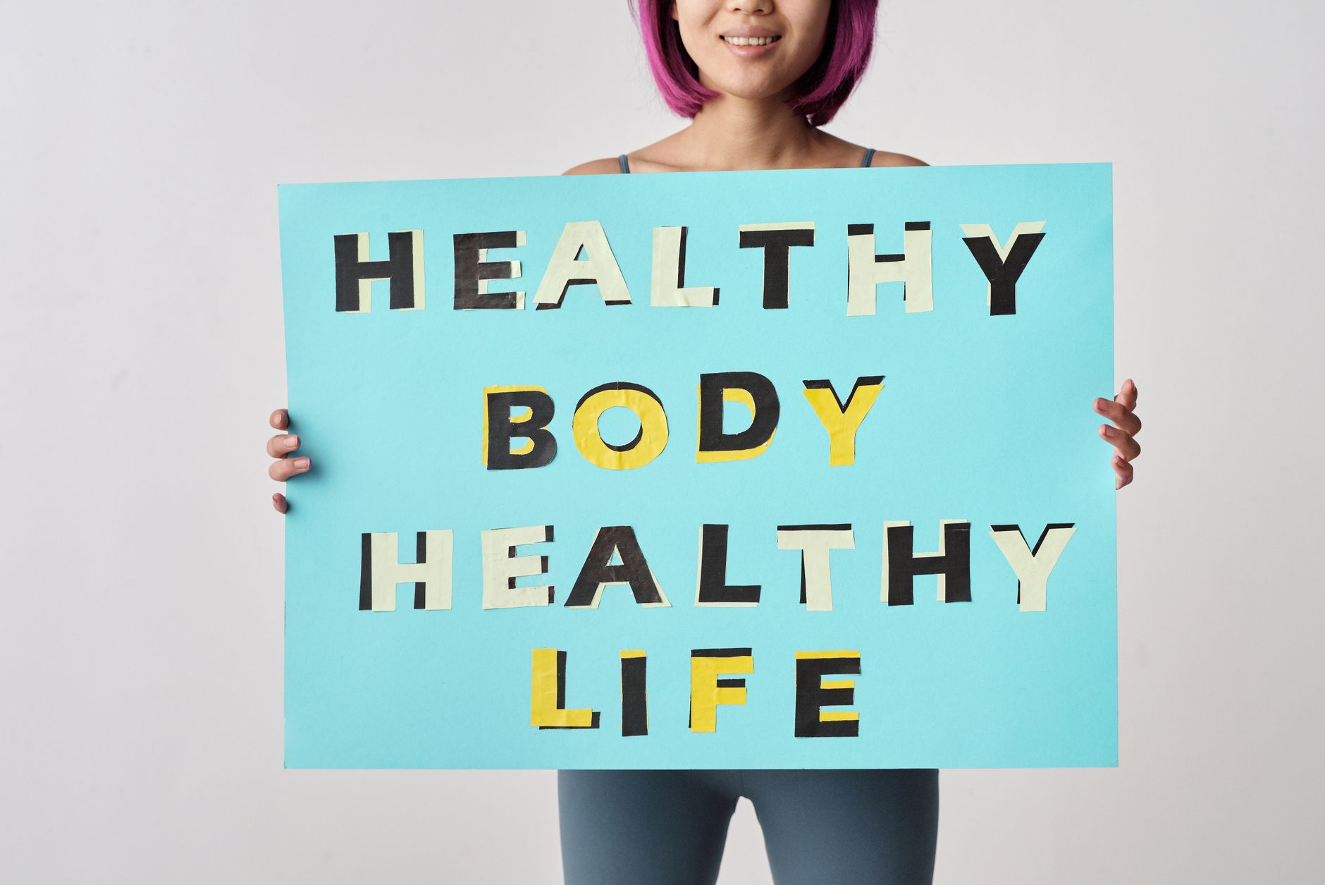 person holding a blue poster with message