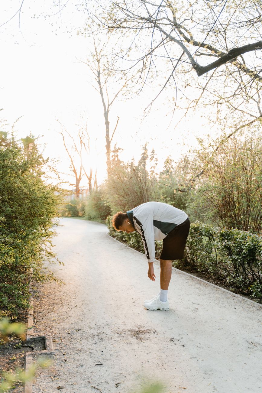 man stretching in a park
